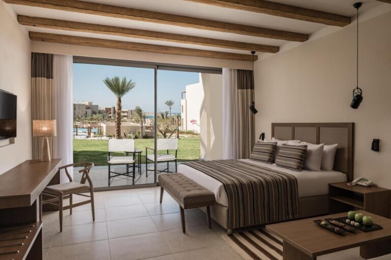 Une chambre au grand lit avec accès direct à la piscine, au JAZ Elite Riviera